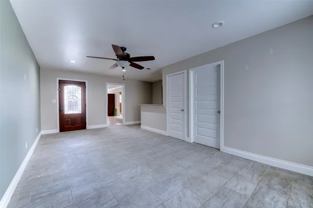 a view of a livingroom with a ceiling fan and window