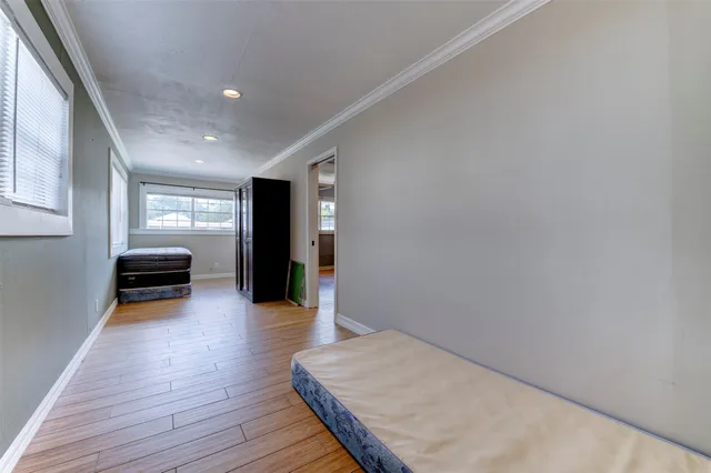 a hallway with wooden floor and furniture