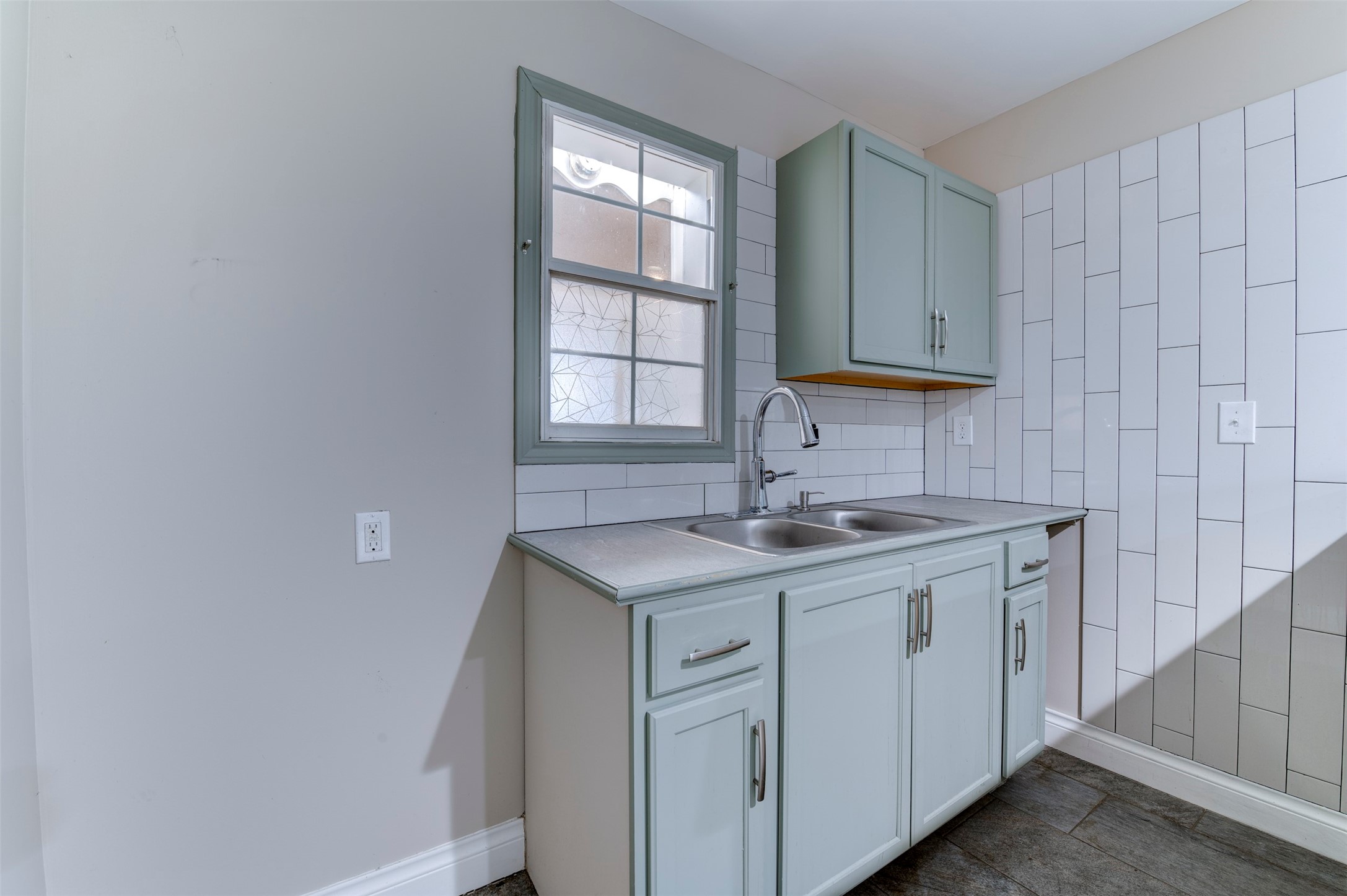 4303 Castor Street Houston, TX 77022 - Photo 25 of 41 a kitchen with a sink cabinets and window