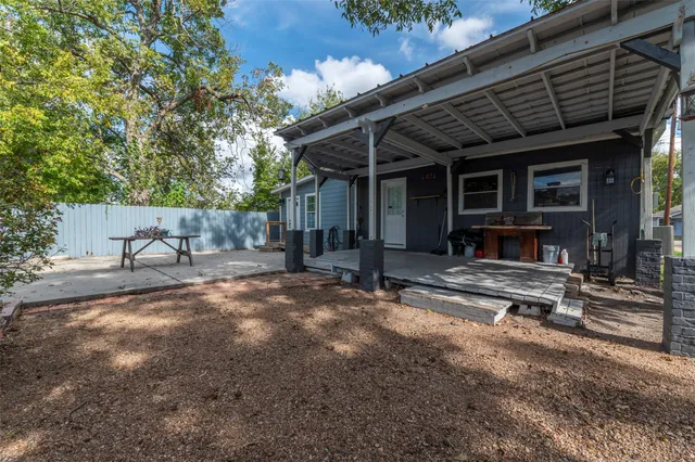 a view of a house with backyard and sitting area