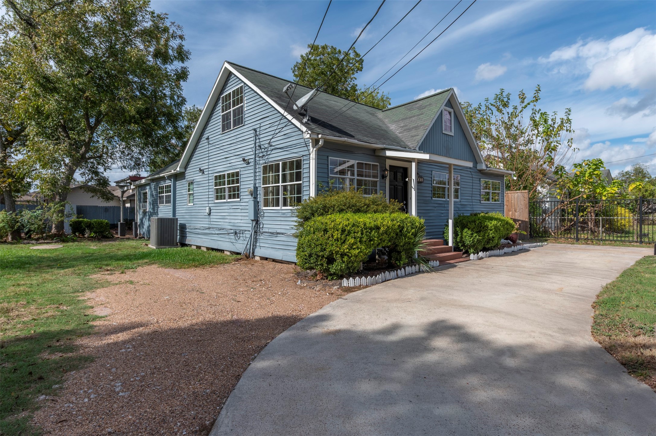 4303 Castor Street Houston, TX 77022 - Photo 3 of 41 a view of a house next to a yard with big trees