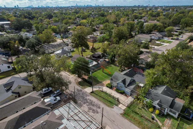 an aerial view of multiple houses with yard