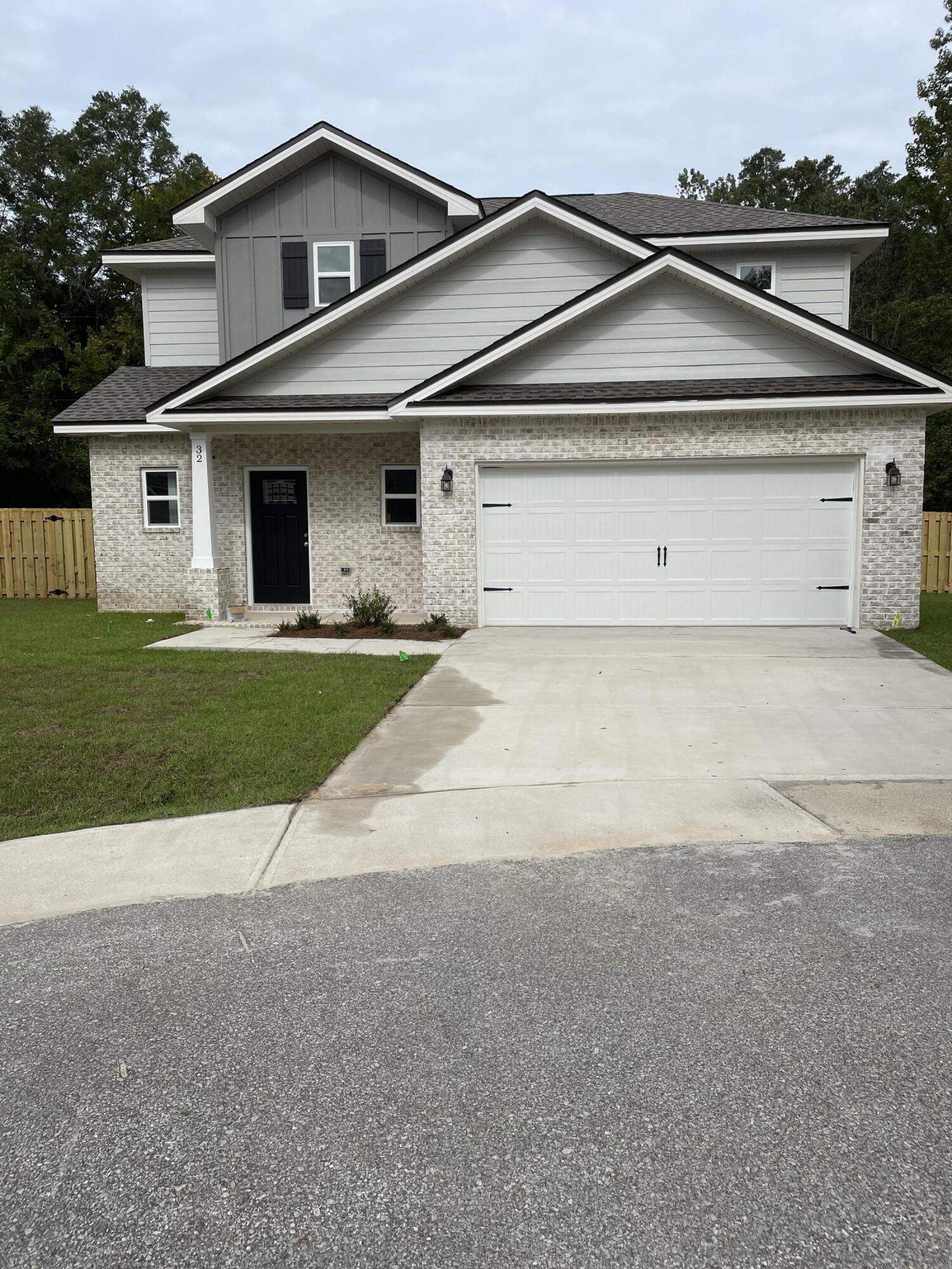 32 Laurel Oaks Drive Freeport, FL 32439 - Photo 1 of 11 a view of a white house with a outdoor space