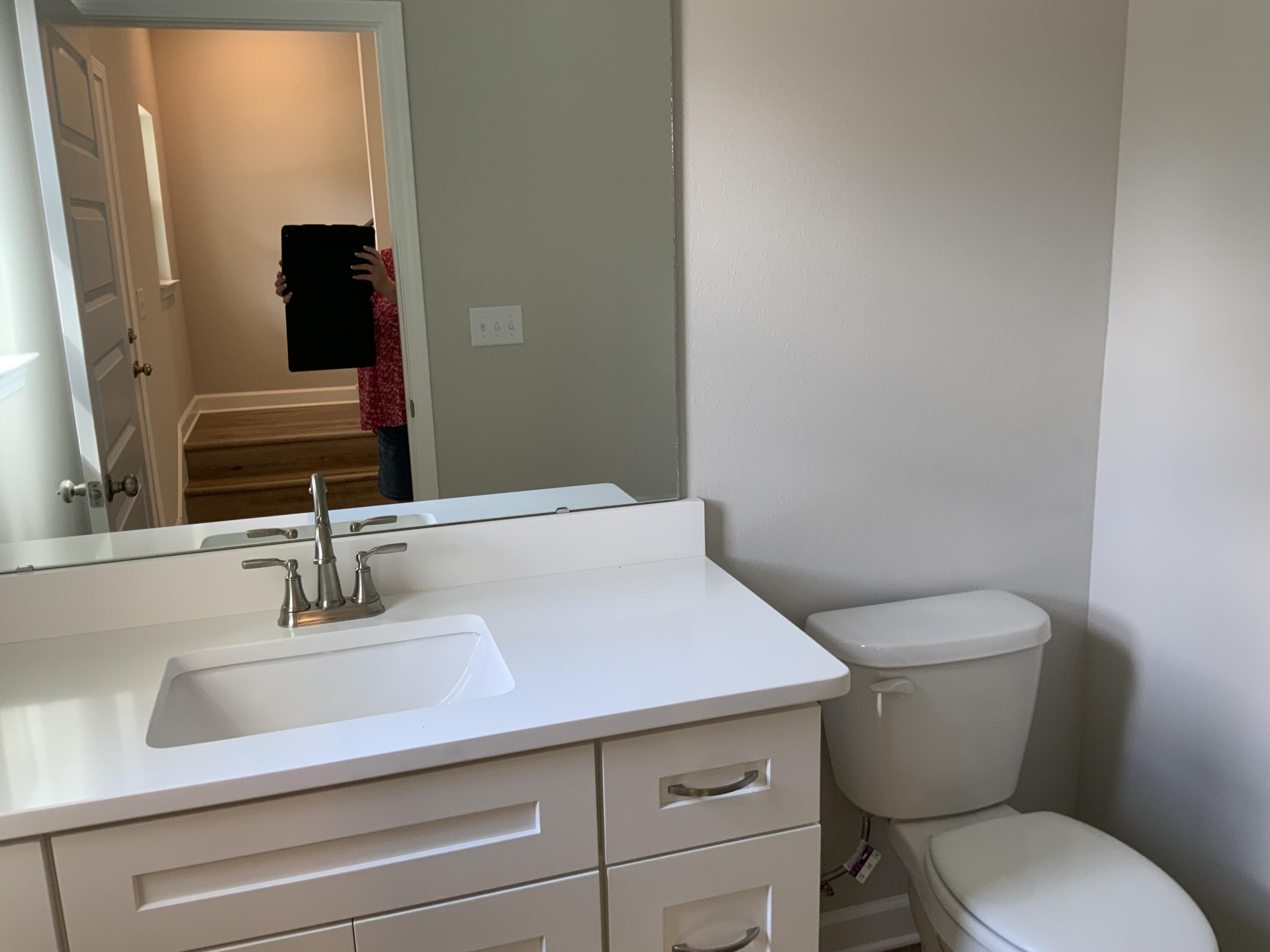 32 Laurel Oaks Drive Freeport, FL 32439 - Photo 4 of 11 a bathroom with a toilet a sink and mirror