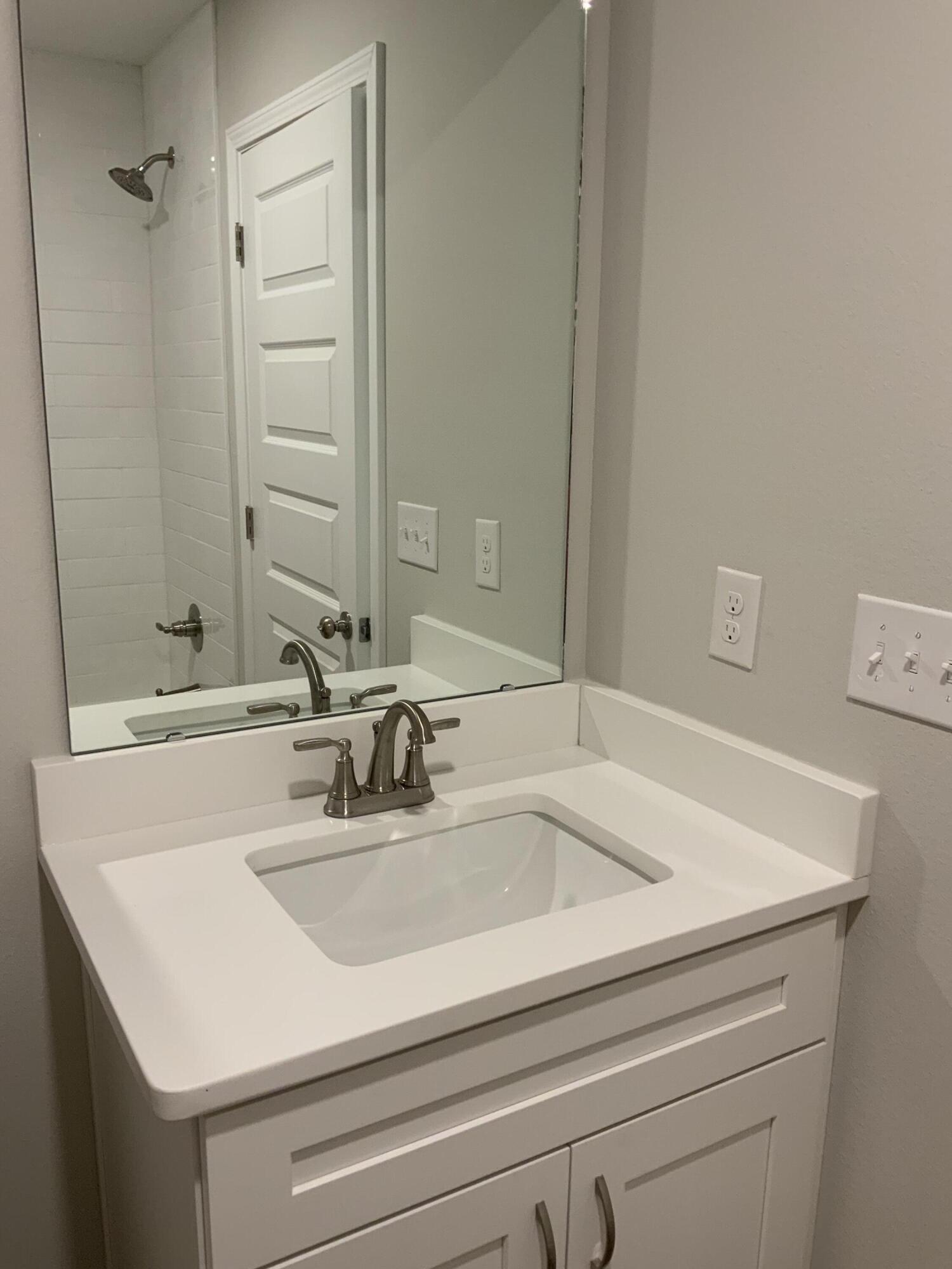 32 Laurel Oaks Drive Freeport, FL 32439 - Photo 7 of 11 a bathroom with a sink and a mirror