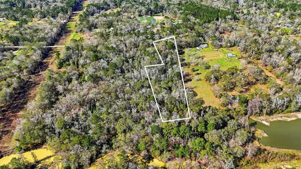 an aerial view of a houses with yard