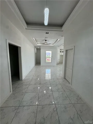 a view of a hallway with a chandelier
