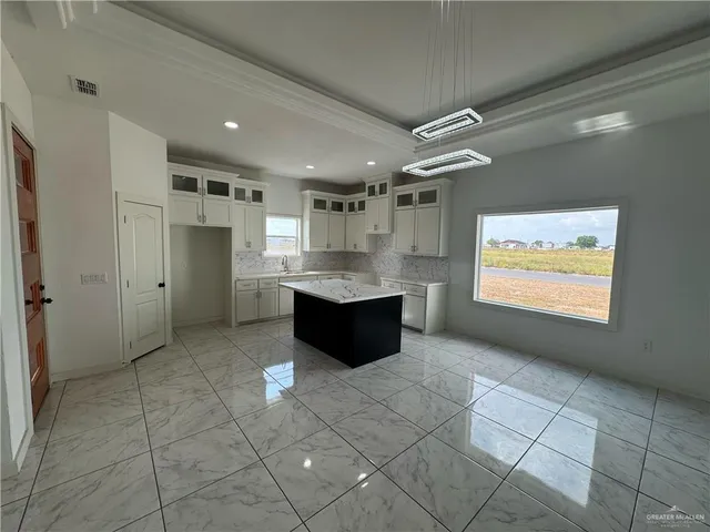 a large bathroom with a large mirror vanity and shower