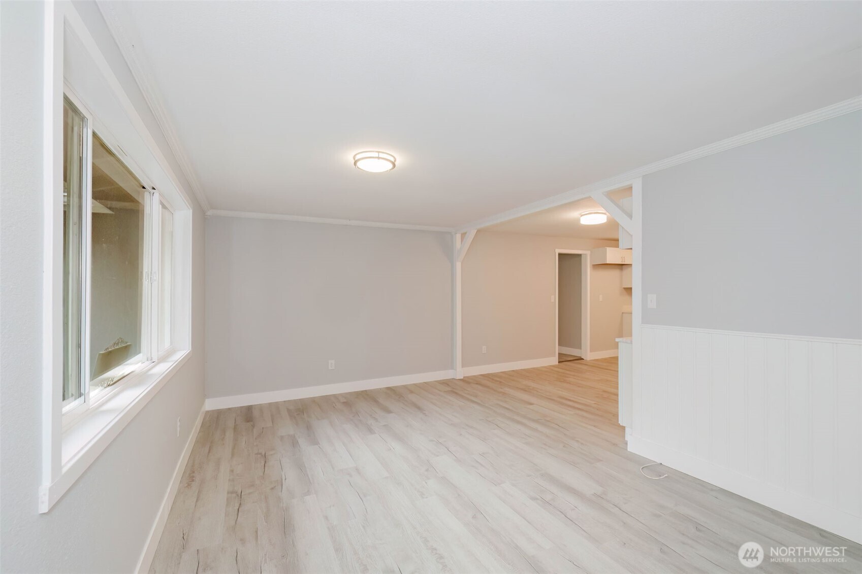 80 East Judy Lane Belfair, WA 98528 - Photo 14 of 40 a view of an empty room with wooden floor and a window