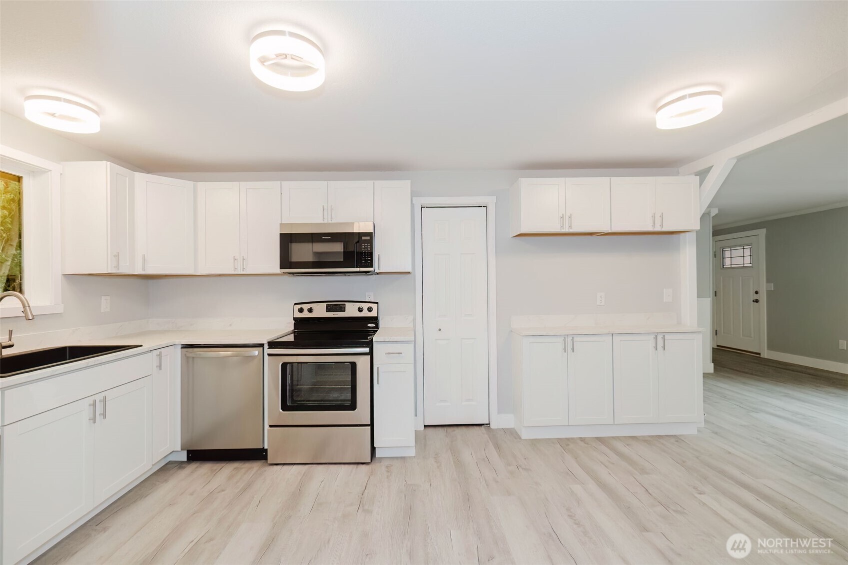 80 East Judy Lane Belfair, WA 98528 - Photo 18 of 40 a kitchen with a sink a microwave and cabinets