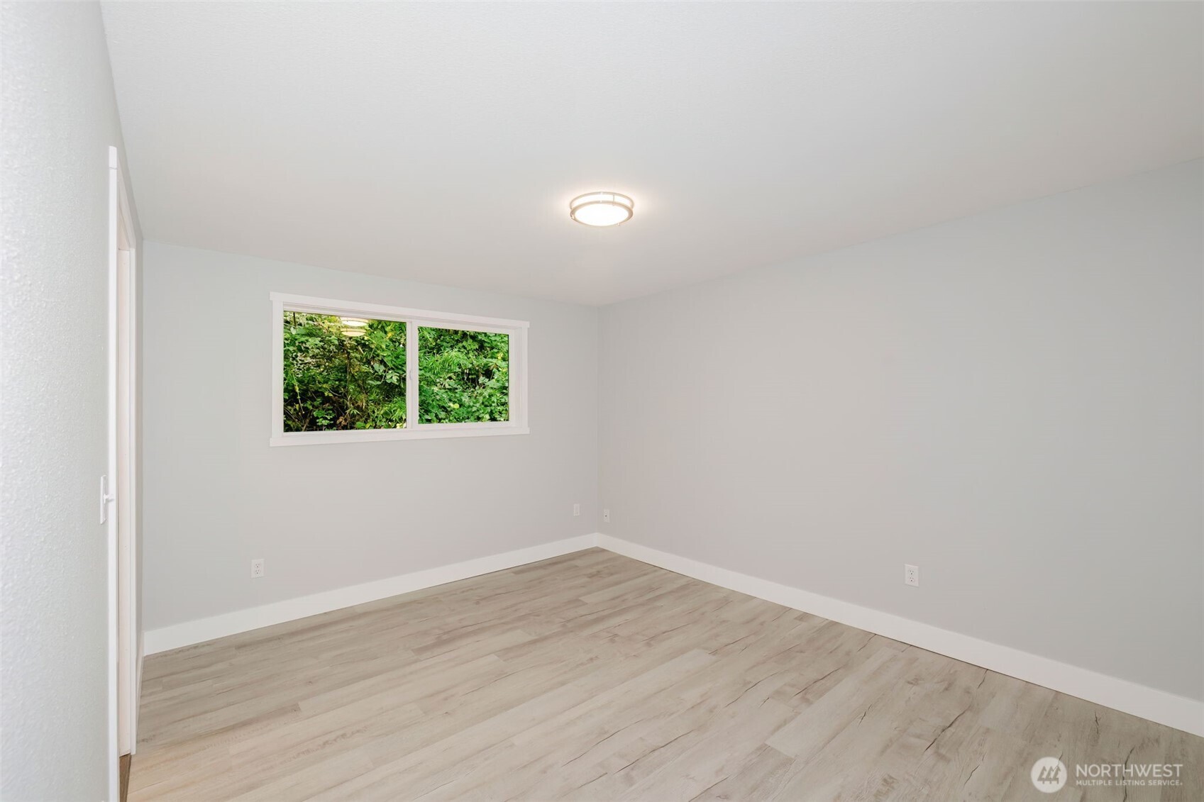 80 East Judy Lane Belfair, WA 98528 - Photo 23 of 40 an empty room with wooden floor and windows