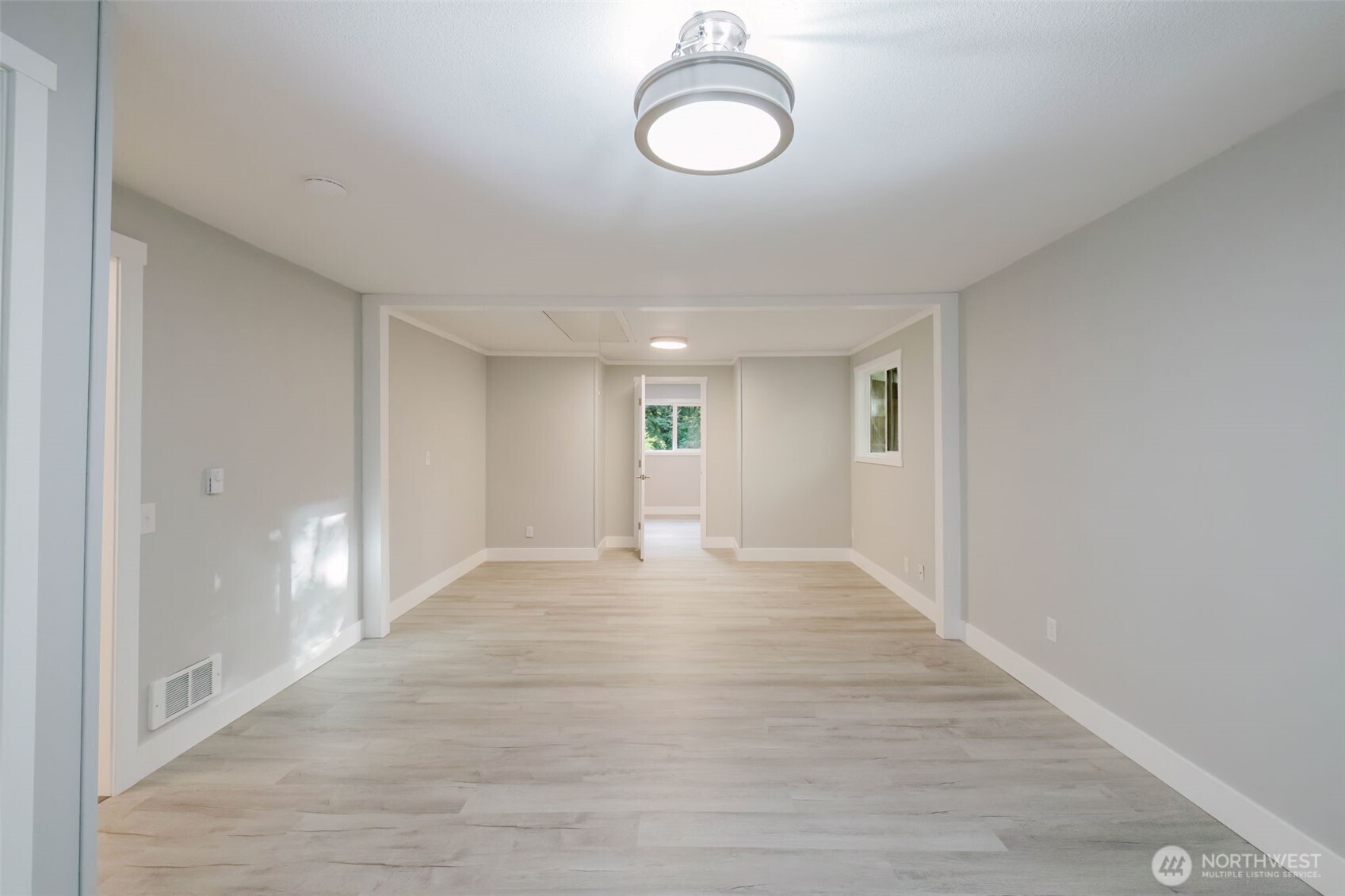 80 East Judy Lane Belfair, WA 98528 - Photo 25 of 40 a view of an empty room with wooden floor and window