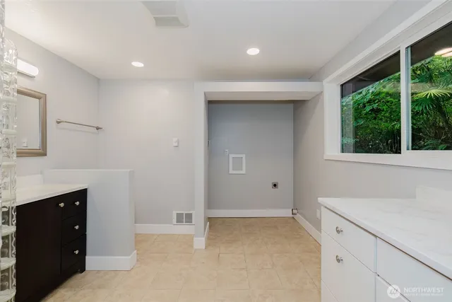 a bathroom with a sink toilet vanity and shower