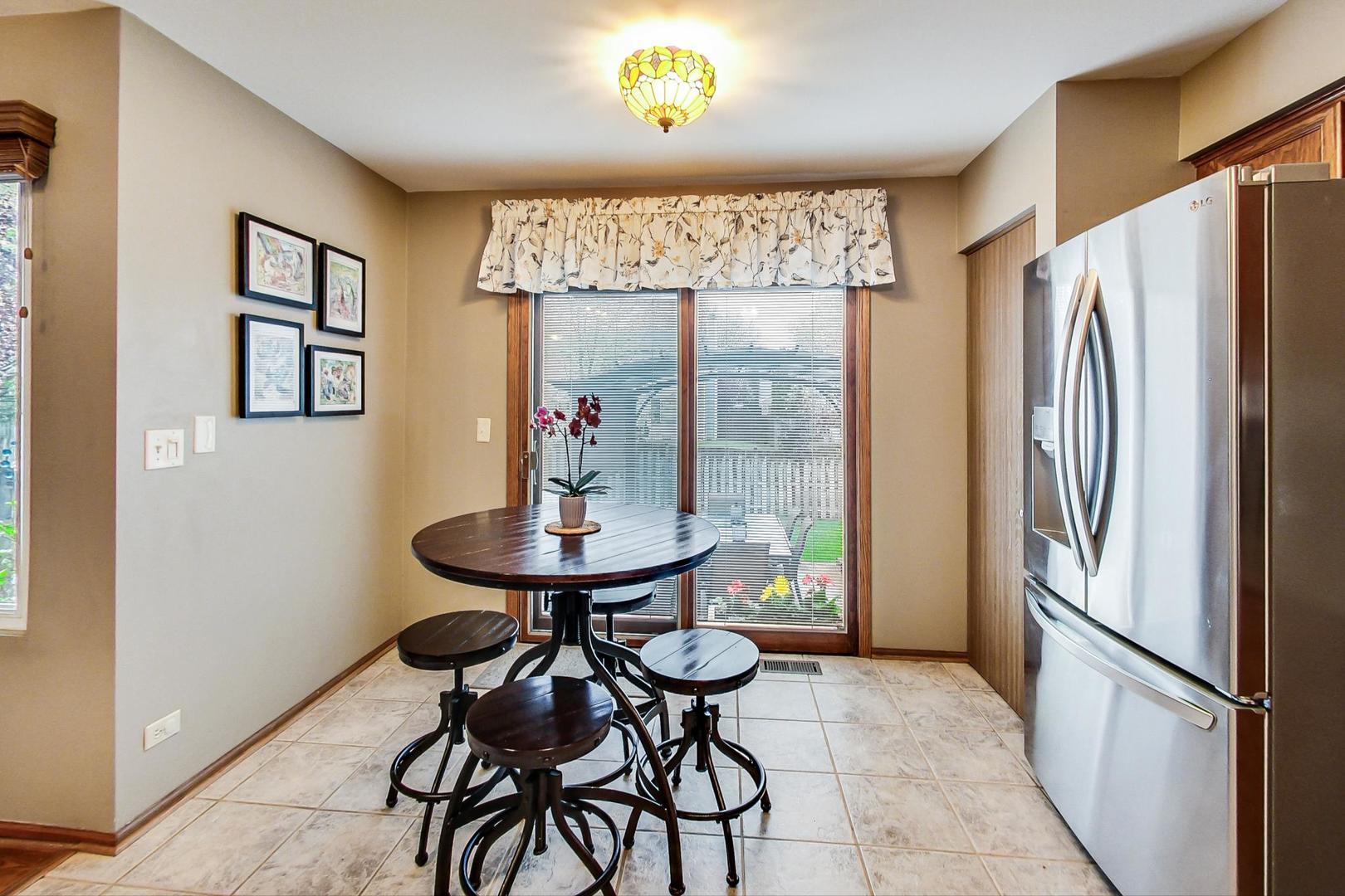 1174 Sweetwater Ridge Lake In The Hills, IL 60156 - Photo 11 of 44 a view of a dining room with furniture and a chandelier