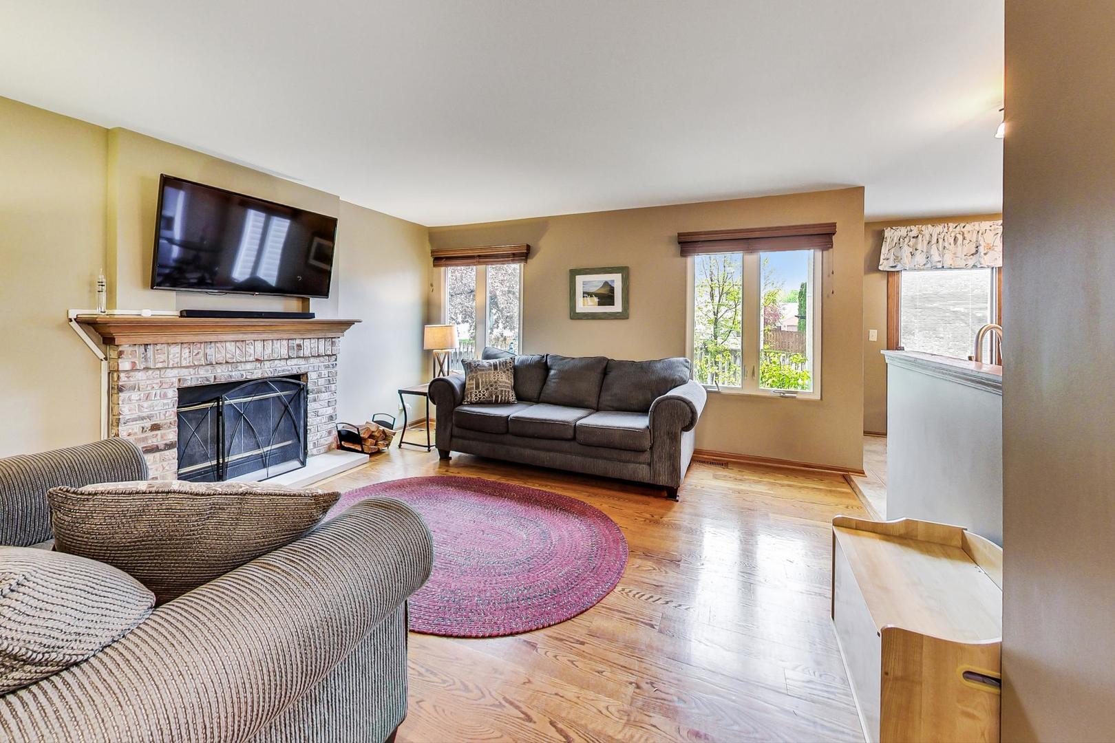 1174 Sweetwater Ridge Lake In The Hills, IL 60156 - Photo 13 of 44 a living room with furniture flat screen tv and a fireplace