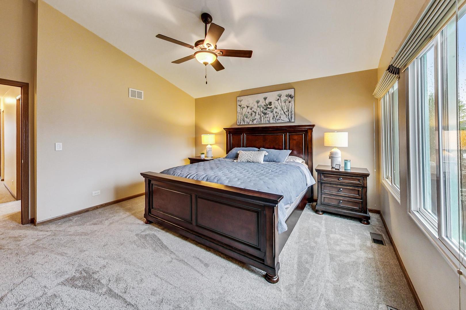 1174 Sweetwater Ridge Lake In The Hills, IL 60156 - Photo 17 of 44 a room with a bed and a chandelier