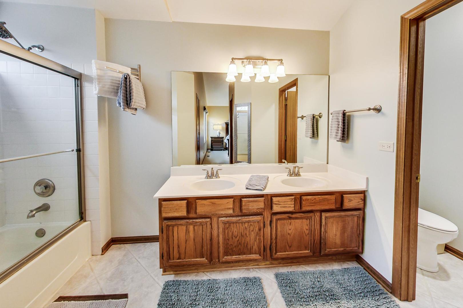 1174 Sweetwater Ridge Lake In The Hills, IL 60156 - Photo 18 of 44 a bathroom with a tub a double vanity sink and mirror