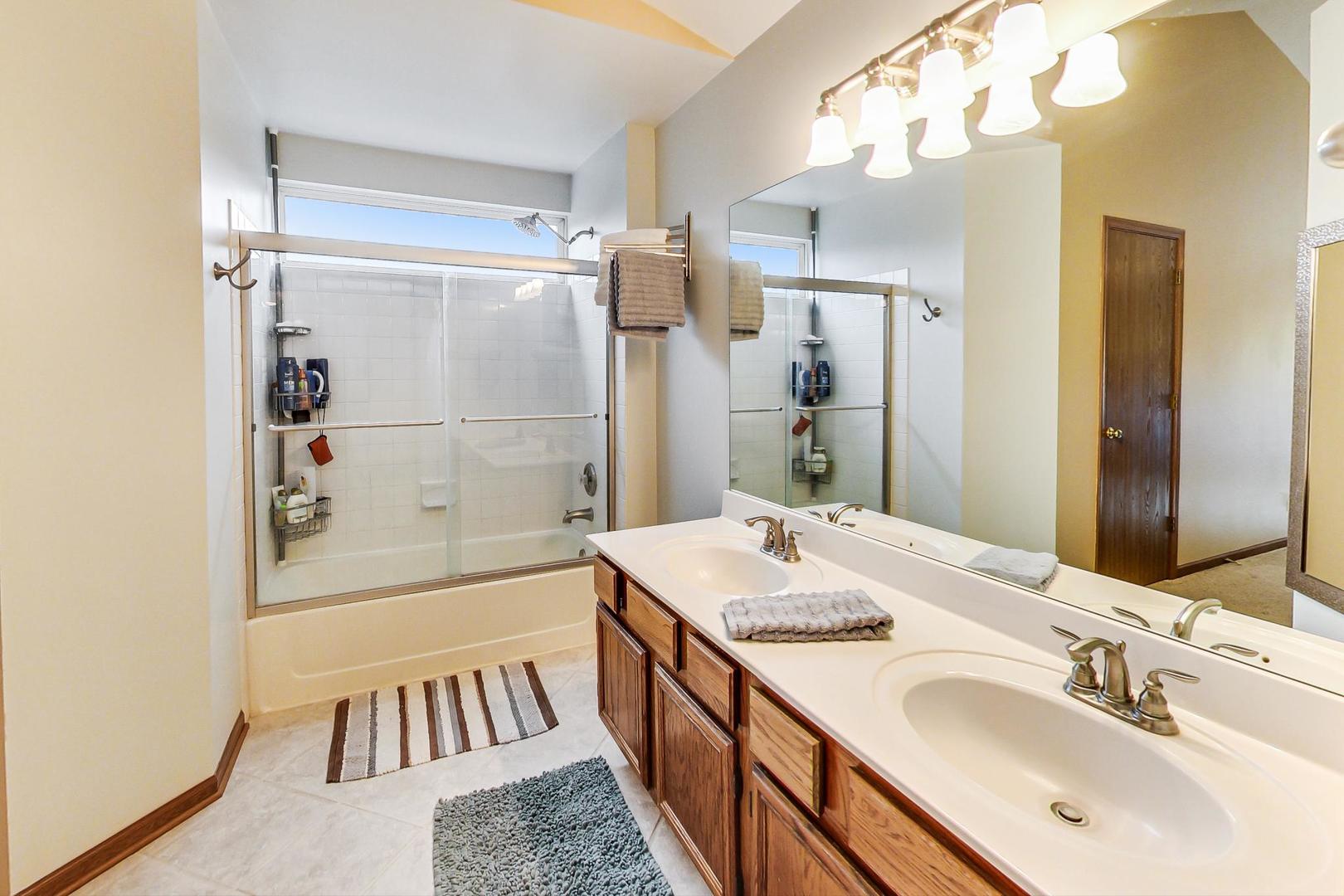 1174 Sweetwater Ridge Lake In The Hills, IL 60156 - Photo 19 of 44 a bathroom with a sink a mirror and a shower