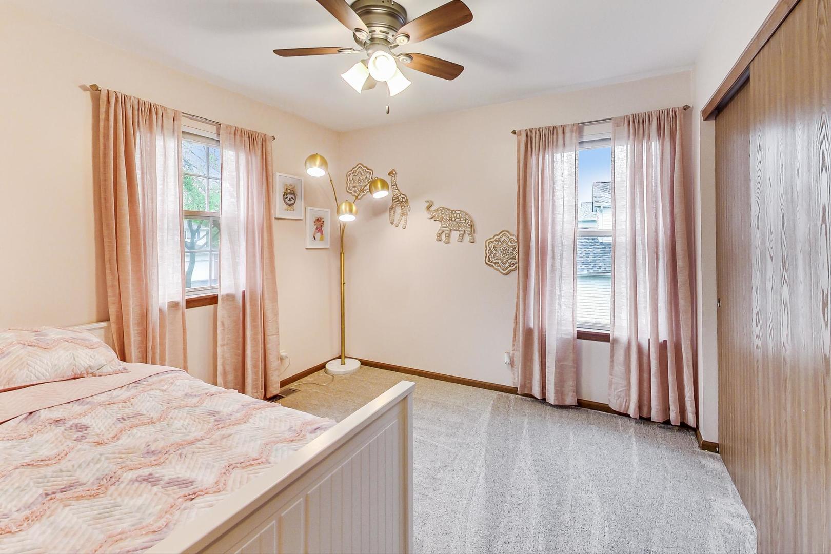 1174 Sweetwater Ridge Lake In The Hills, IL 60156 - Photo 20 of 44 a view of a bedroom with a chandelier fan and a window