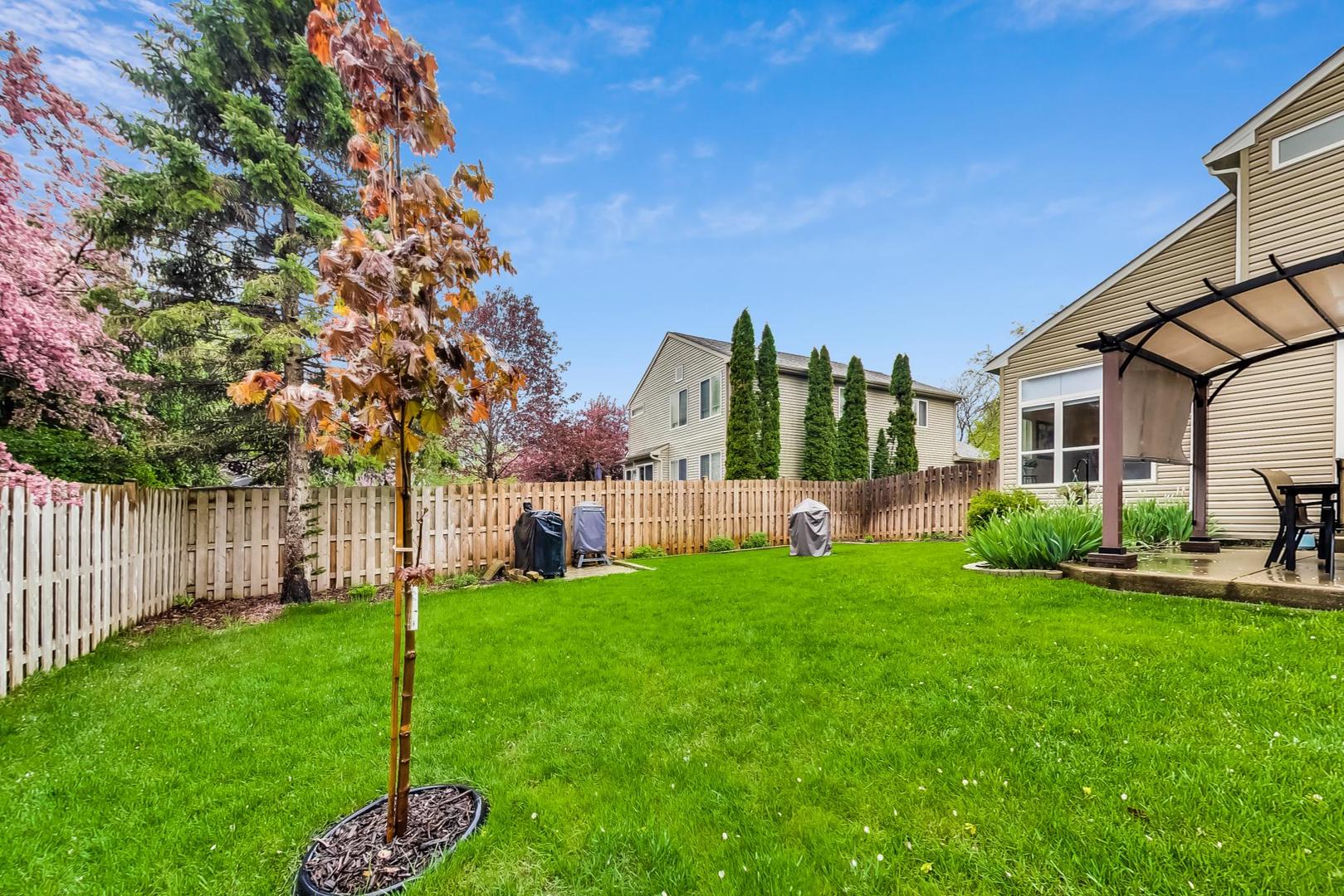 1174 Sweetwater Ridge Lake In The Hills, IL 60156 - Photo 39 of 44 a view of a house with a yard and sitting area