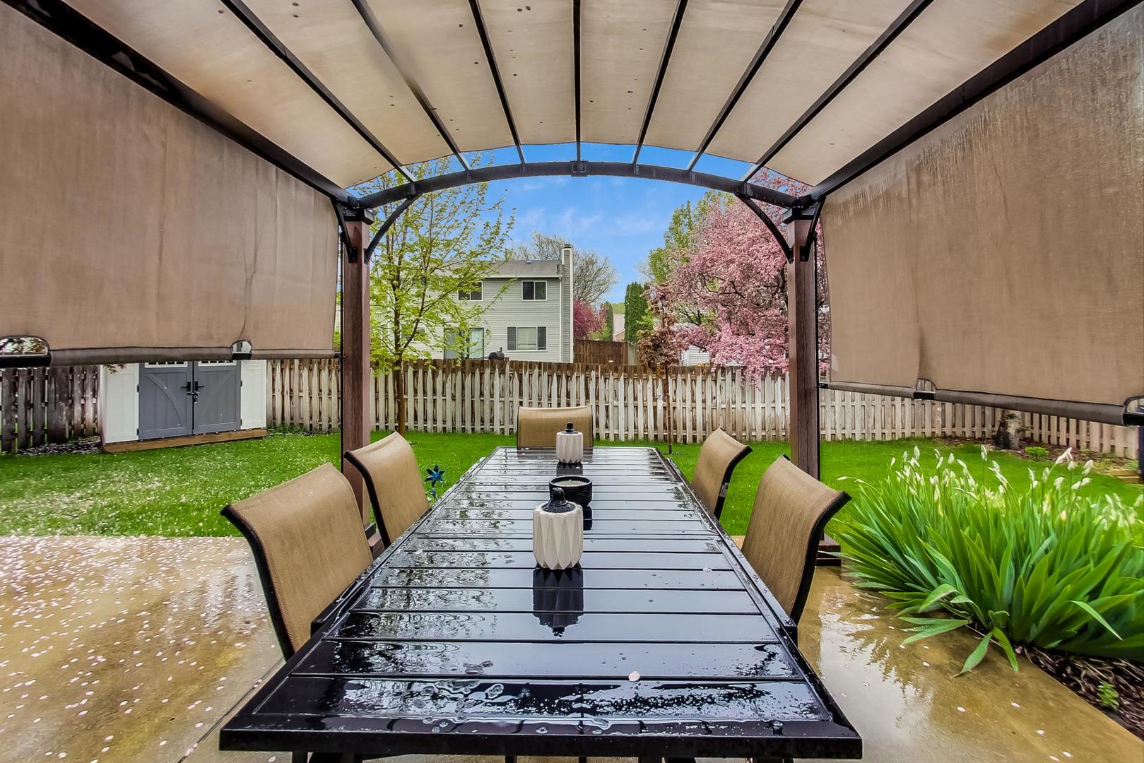 1174 Sweetwater Ridge Lake In The Hills, IL 60156 - Photo 40 of 44 a view of a patio with table and chairs potted plants with wooden floor