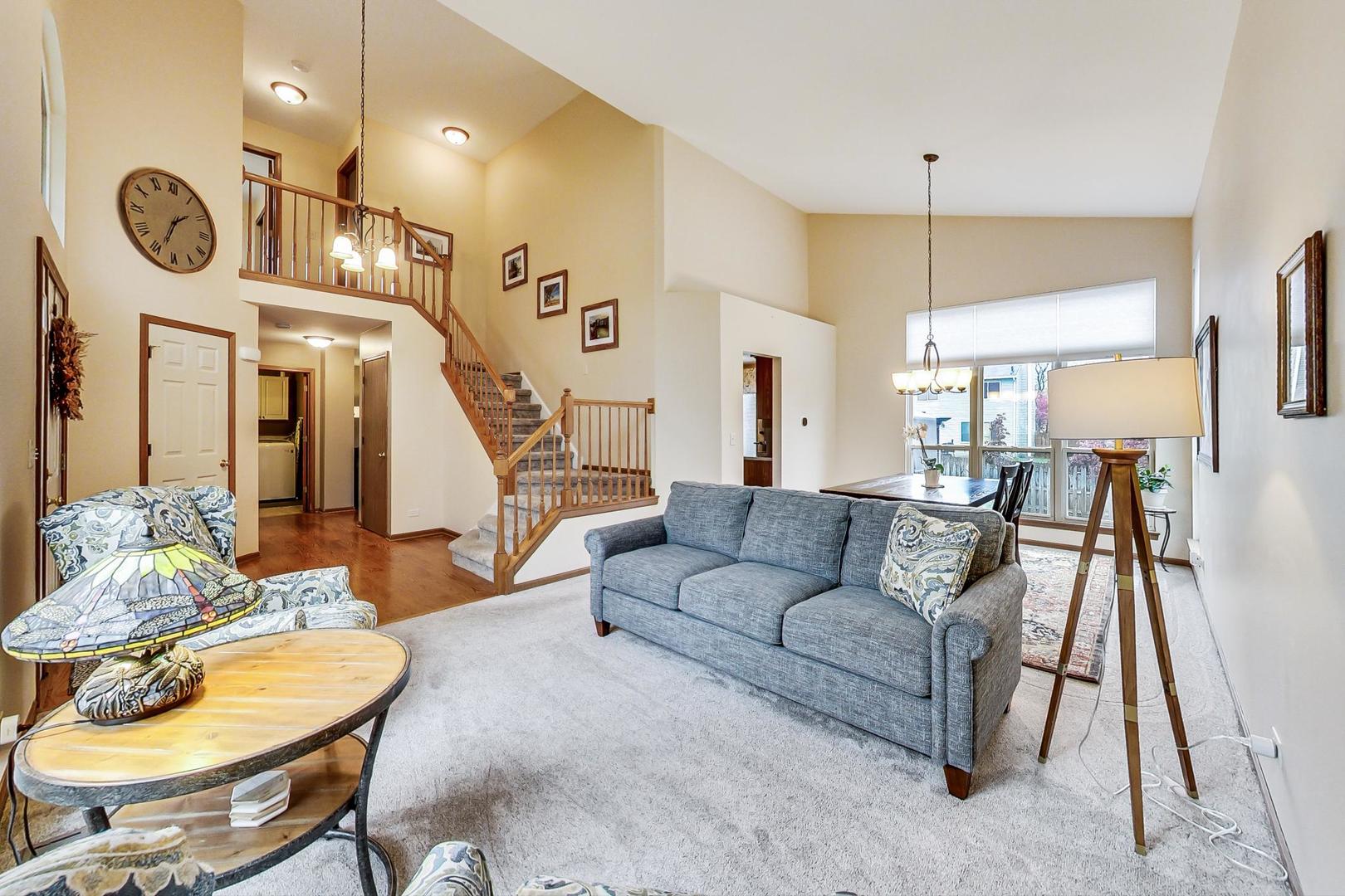 1174 Sweetwater Ridge Lake In The Hills, IL 60156 - Photo 4 of 44 a living room with furniture and a chandelier