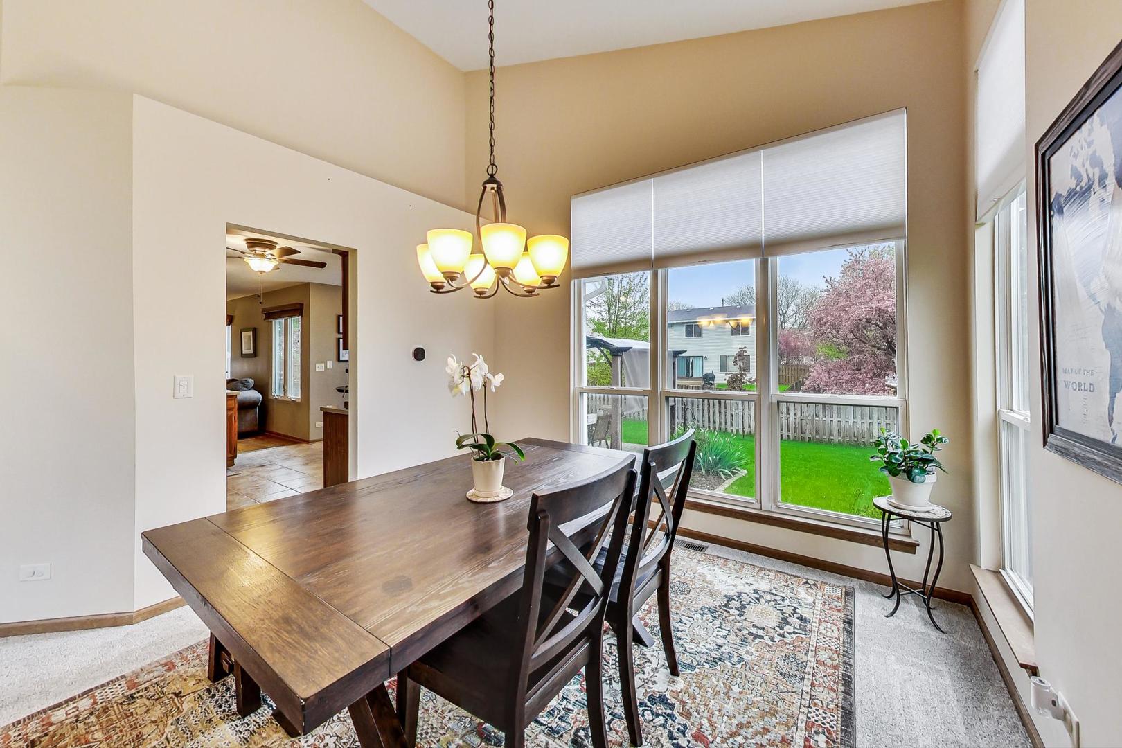1174 Sweetwater Ridge Lake In The Hills, IL 60156 - Photo 6 of 44 a view of a dining room with furniture window and wooden floor