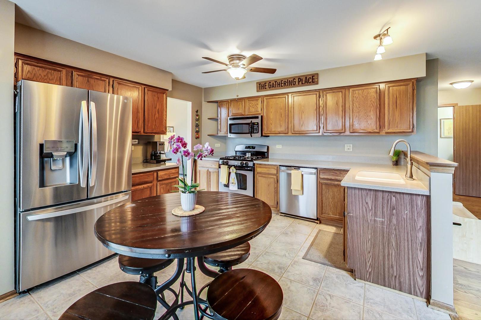 1174 Sweetwater Ridge Lake In The Hills, IL 60156 - Photo 8 of 44 a kitchen with refrigerator a sink and a refrigerator