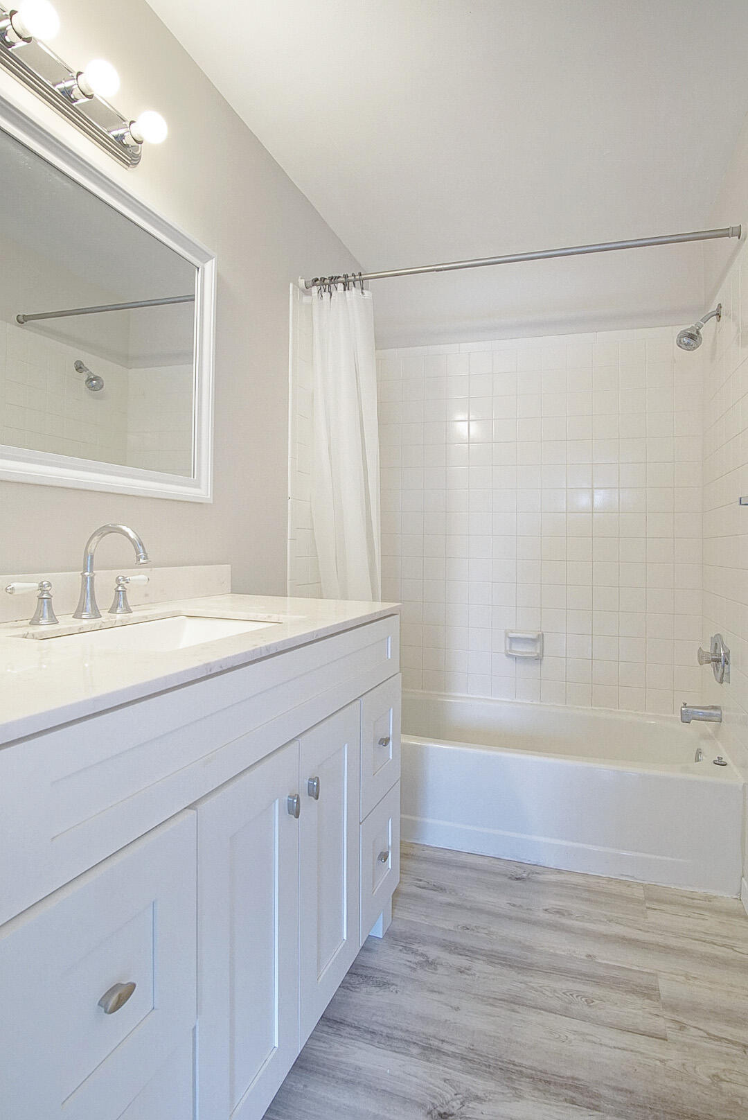 4206 Inlet Circle Greenacres, FL 33463 - Photo 13 of 30 a bathroom with a double vanity sink a mirror and a bathtub