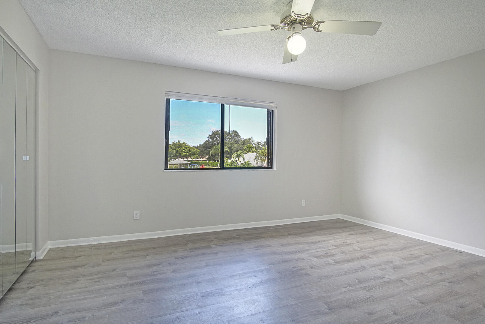 4206 Inlet Circle Greenacres, FL 33463 - Photo 15 of 30 wooden floor in an empty room with a window
