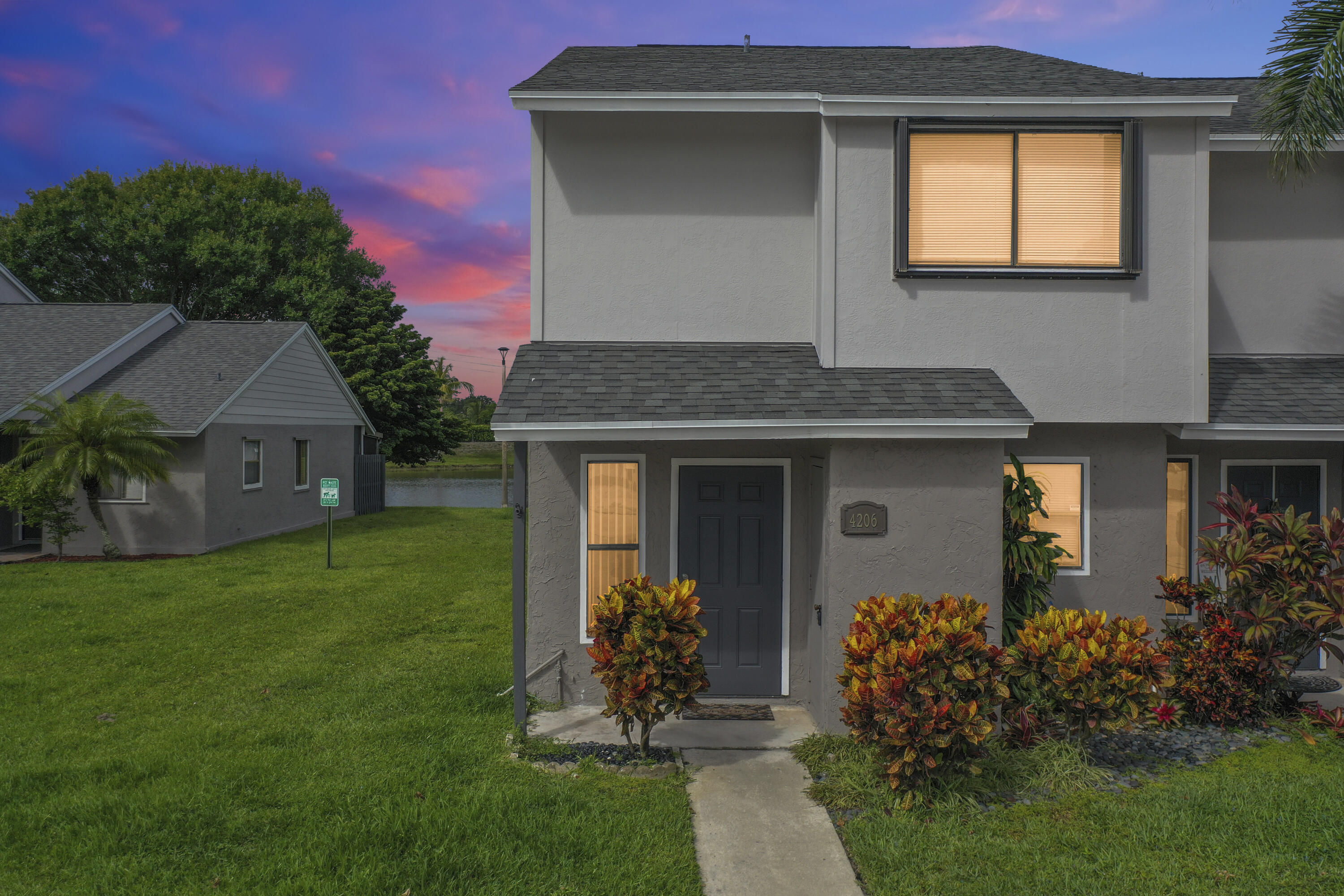 4206 Inlet Circle Greenacres, FL 33463 - Photo 22 of 30 a front view of a house with garden