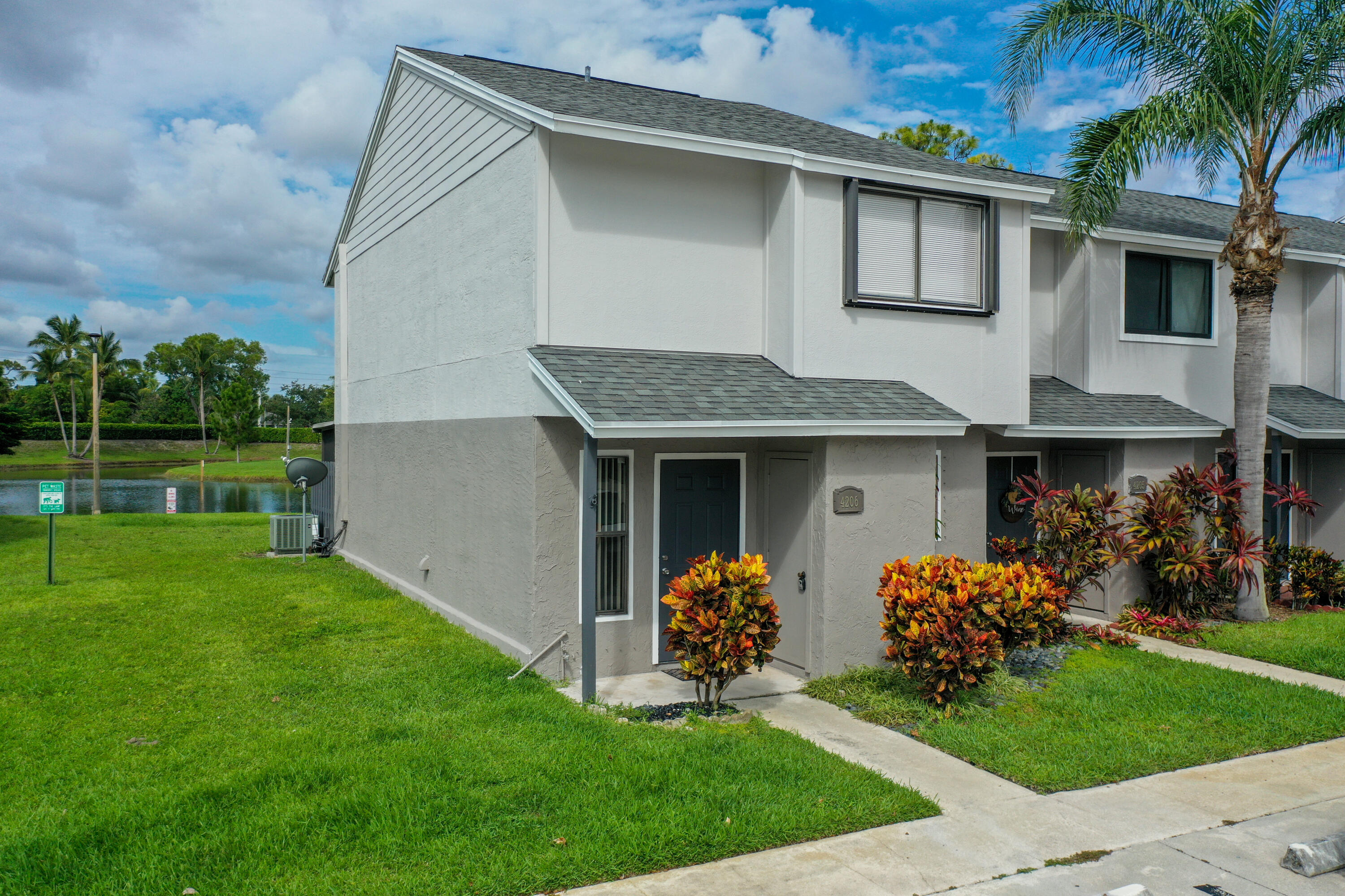4206 Inlet Circle Greenacres, FL 33463 - Photo 23 of 30 a front view of a house with garden
