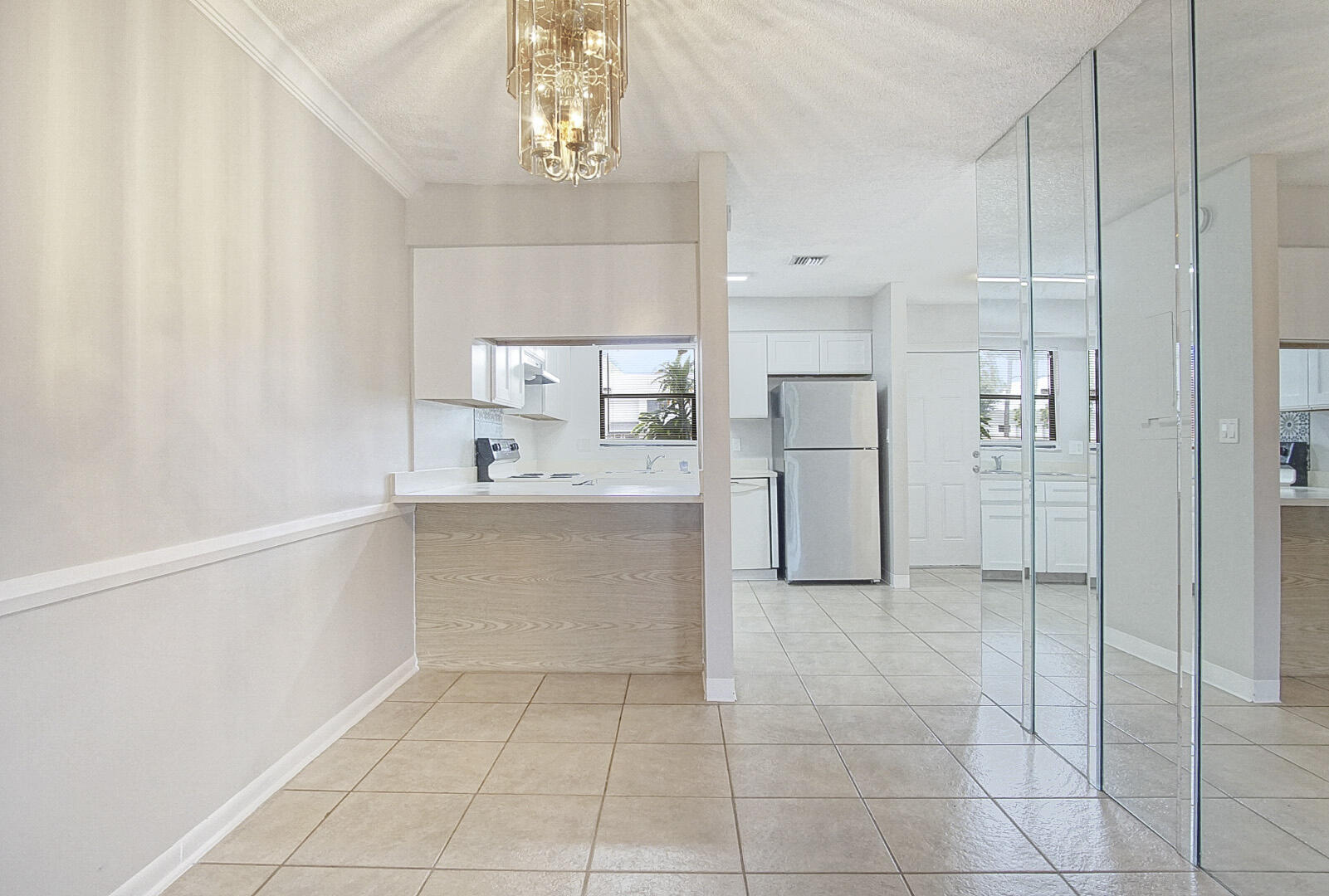 4206 Inlet Circle Greenacres, FL 33463 - Photo 5 of 30 a large white kitchen with a sink and dishwasher a refrigerator with white cabinets