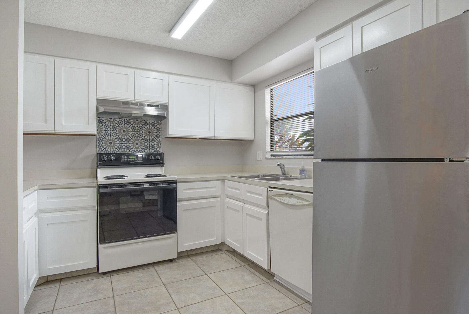4206 Inlet Circle Greenacres, FL 33463 - Photo 6 of 30 a kitchen with stainless steel appliances granite countertop a refrigerator sink and cabinets