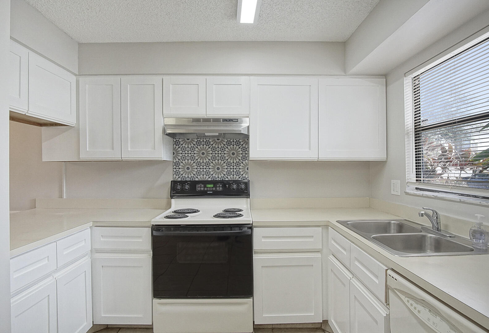 4206 Inlet Circle Greenacres, FL 33463 - Photo 7 of 30 a kitchen with a sink stove and cabinets