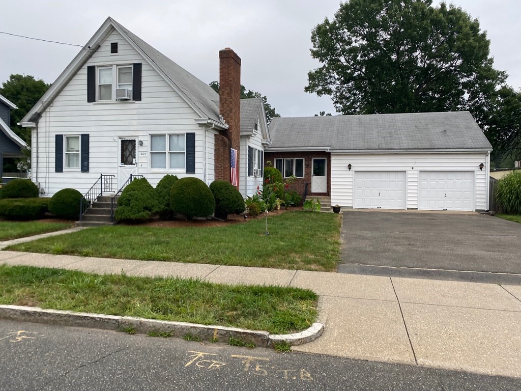 263 Abbott Street Springfield, MA 01118 - Photo 1 of 24 a front view of a house with a garden