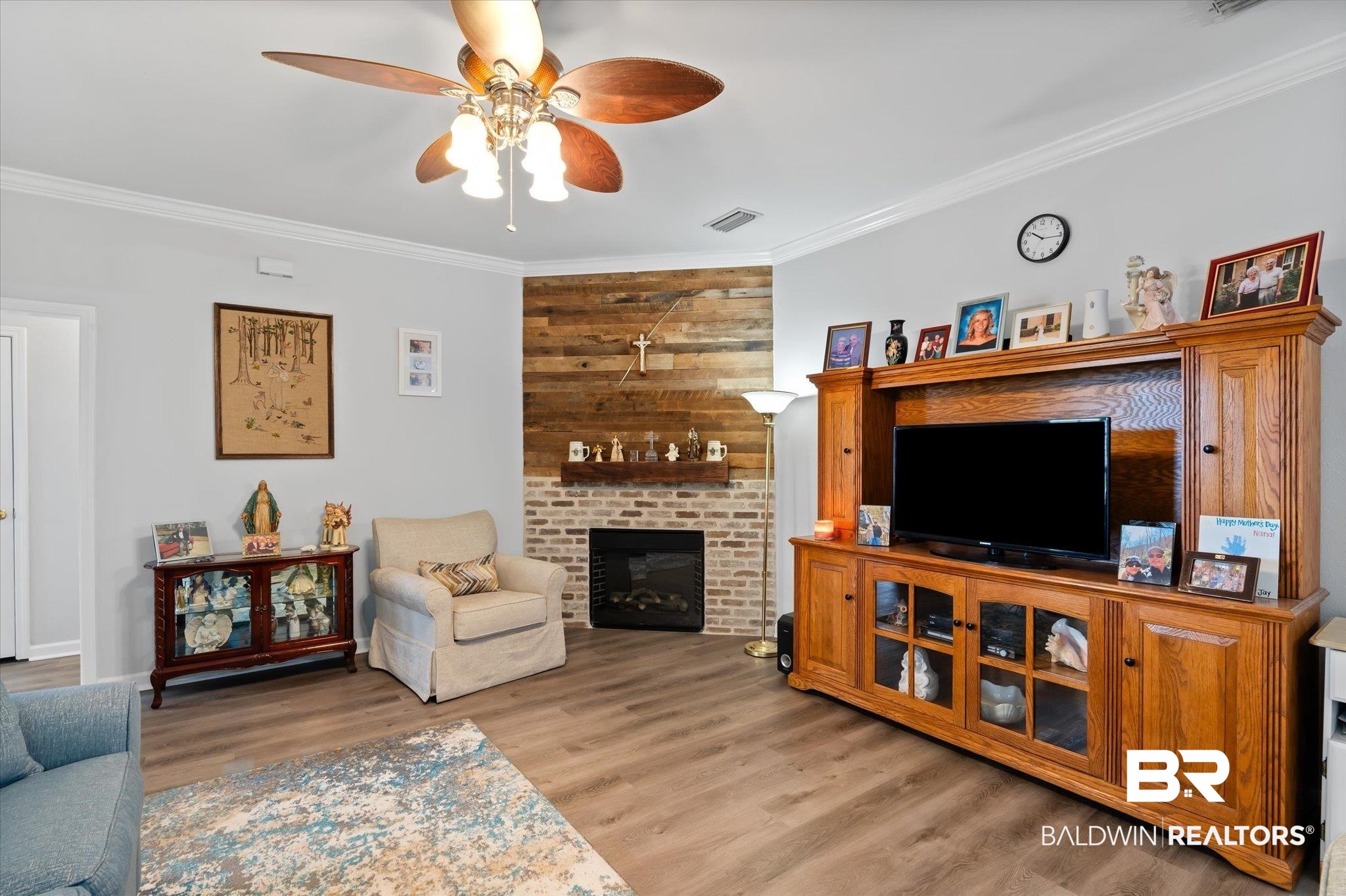 3876 Emerille Drive Foley, AL 36535 - Photo 5 of 31 Living room with a fireplace, light hardwood / wood-style floors, ceiling fan, and ornamental molding