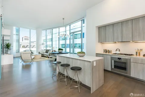 a living room with granite countertop furniture a stove a sink and a large window