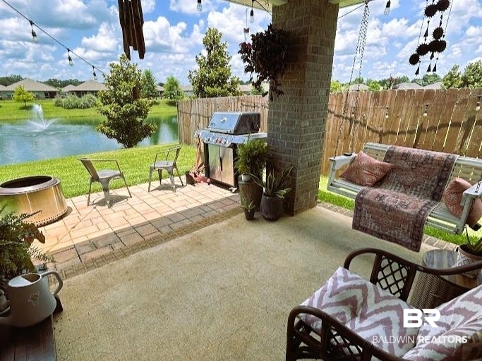 8353 Irwin Loop Daphne, AL 36526 - Photo 36 of 39 Fenced backyard featuring a patio, a water view, and grilling area