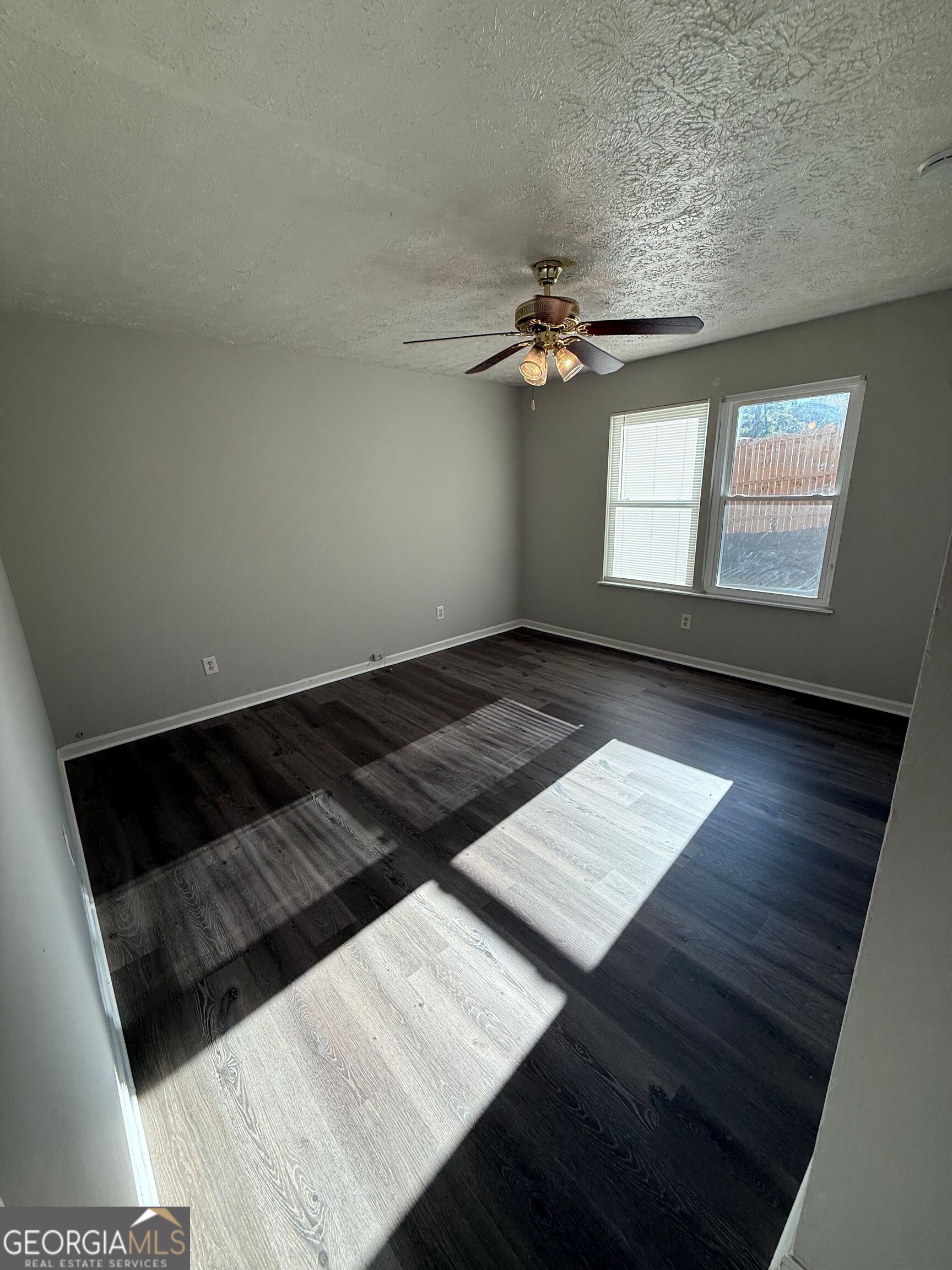 250 Toby Springs Lane McDonough, GA 30253 - Photo 8 of 10 wooden floor in an empty room with a window