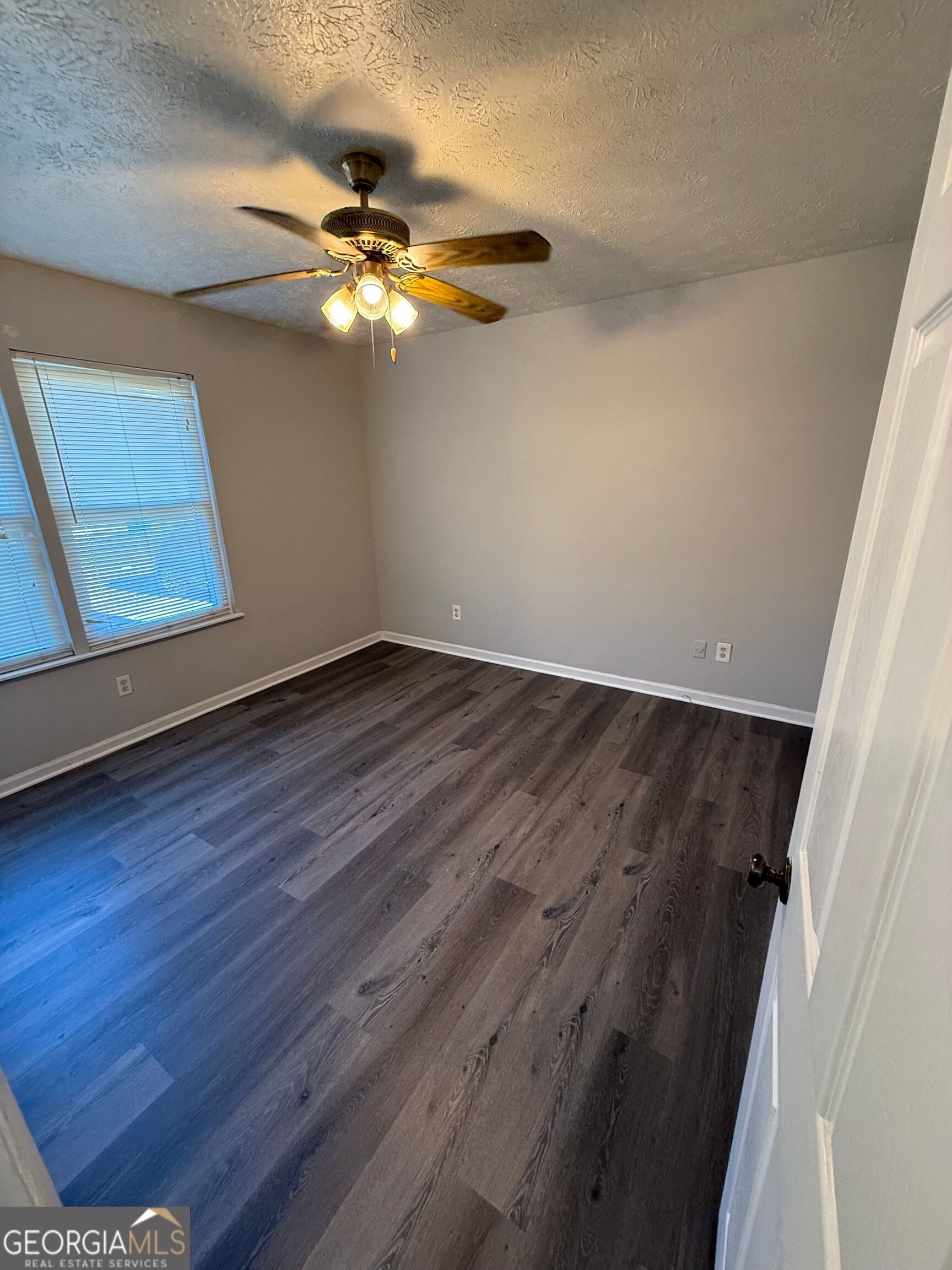 250 Toby Springs Lane McDonough, GA 30253 - Photo 9 of 10 wooden floor in an empty room with a window