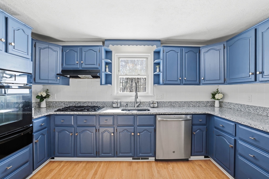 46 Brookwood Road Hanover, MA 02339 - Photo 11 of 41 a kitchen with stainless steel appliances granite countertop wooden cabinets and a sink