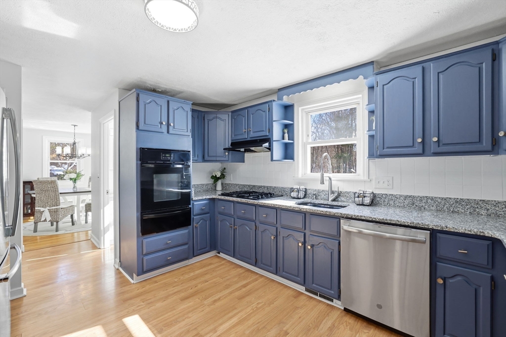 46 Brookwood Road Hanover, MA 02339 - Photo 12 of 41 a kitchen with granite countertop a stove cabinets and refrigerator