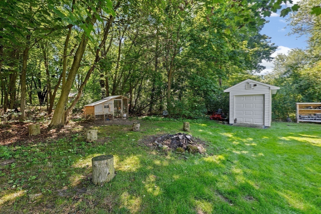 46 Brookwood Road Hanover, MA 02339 - Photo 38 of 41 a view of a backyard with table and chairs and a large tree