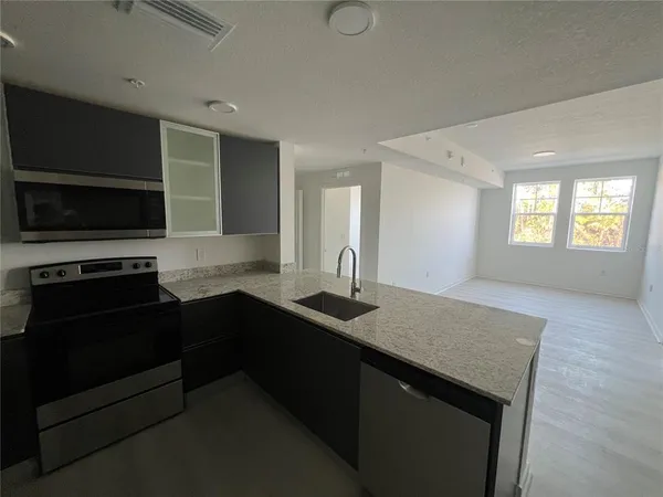 a kitchen with a sink and a stove top oven