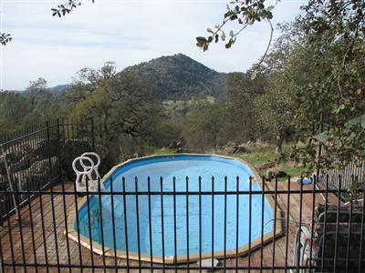 20164 Nicholas Road Prather, CA 93651 - Photo 51 of 67 Fenced above, vinyl pool with surrounding deck and awesome views...summer relaxation with mountain privacy