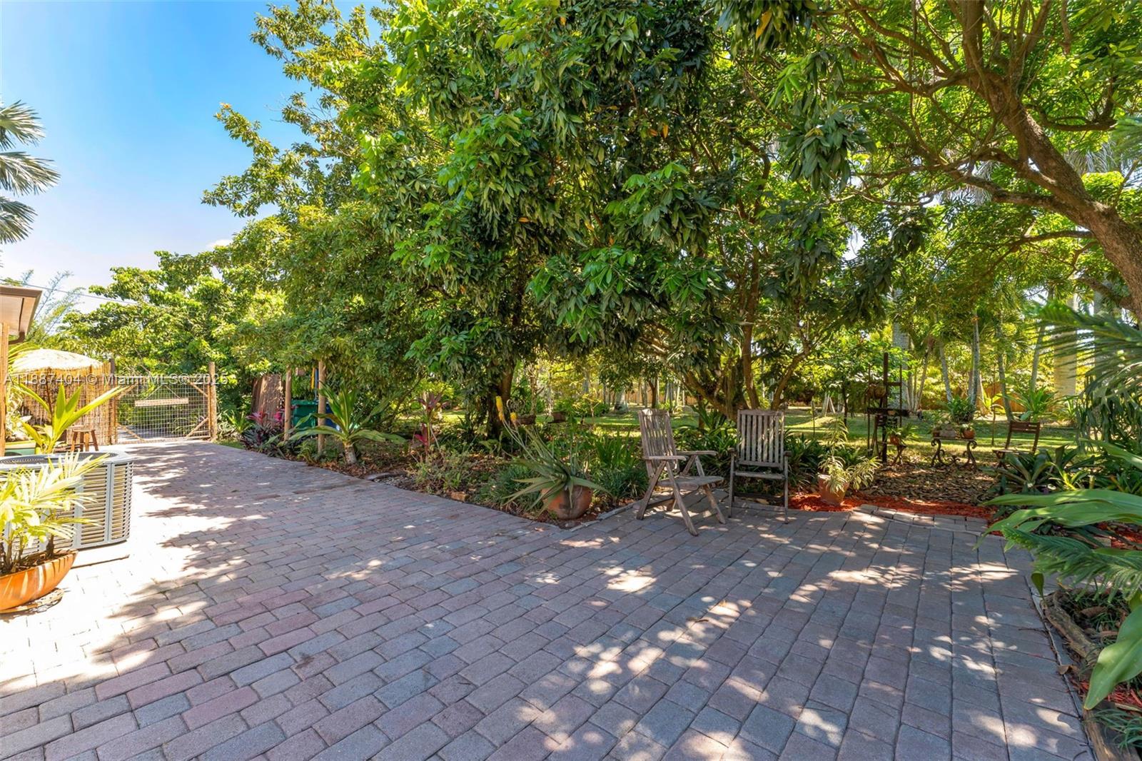 20230 Southwest 184th Street Miami, FL 33187 - Photo 29 of 42 Sitting area's off of the meandering pathways allows a nice walk thru out LA CHAKANA.