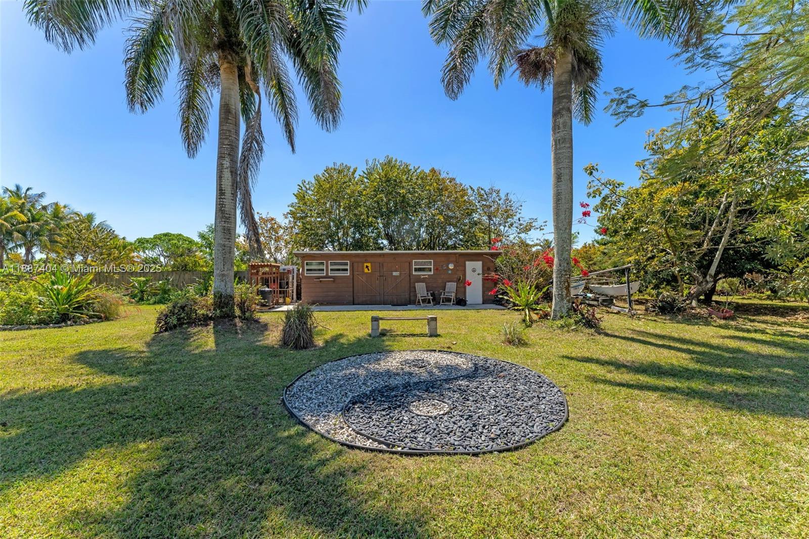 20230 Southwest 184th Street Miami, FL 33187 - Photo 30 of 42 The barn / storage sits at the back of the property & like everything else has power/ water access. Love the rock mosaic. THE PROPERTY HAS GREAT ENERGY AND A LAID BACK VIBE.YOU ARE OFF THE CRAZY TRAIN AND CAN BREATHE.