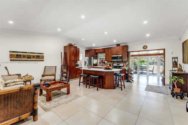 a living room with furniture and a dining table with kitchen view