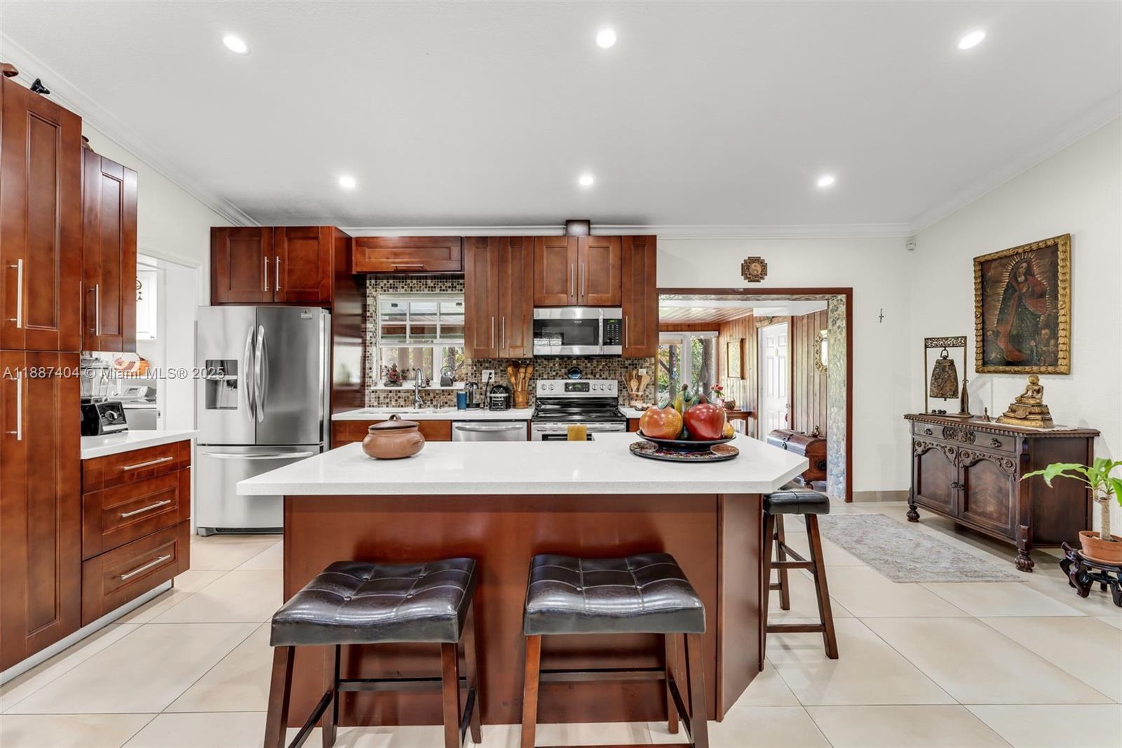 20230 Southwest 184th Street Miami, FL 33187 - Photo 7 of 42 Beautiful kitchen overlooking living room w/ vaulted ceilings, oversized tile, sitting in the center of the 3 way split floorplan.